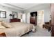 Comfortable main bedroom showcasing a large bed and ensuite bathroom through an open doorway at 1242 Petit Verdot Dr, Westfield, IN 46074