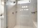 Luxurious tiled shower with a glass door, showcasing modern fixtures and a built-in bench at 1242 Petit Verdot Dr, Westfield, IN 46074