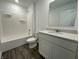 Bright bathroom with a white tub/shower combination and a white vanity with a large mirror at 1319 Fleming Dr, Greenfield, IN 46140