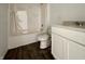 Modern bathroom featuring a tub shower, white vanity with double sinks and wood look flooring at 1319 Fleming Dr, Greenfield, IN 46140
