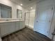 Bathroom featuring double sinks, marble countertops, a white shower with a glass door, and grey flooring at 1319 Fleming Dr, Greenfield, IN 46140