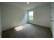 Bedroom with carpet flooring and a window letting in light from outside, with white walls and trim at 1319 Fleming Dr, Greenfield, IN 46140