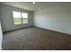 Bedroom featuring carpet flooring and a window letting in light from outside, with white walls and trim at 1319 Fleming Dr, Greenfield, IN 46140