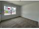 Cozy bedroom with neutral carpet, window, and fresh white walls at 1319 Fleming Dr, Greenfield, IN 46140