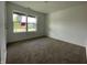 Bedroom with carpet flooring and a window letting in light from outside, with white walls and trim at 1319 Fleming Dr, Greenfield, IN 46140