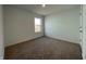 Bedroom with carpet flooring and a window letting in light from outside, with white walls and trim at 1319 Fleming Dr, Greenfield, IN 46140