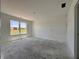 Unfinished bedroom featuring a large window with natural light and grey concrete floors at 1319 Fleming Dr, Greenfield, IN 46140