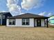 New construction home with white siding, black trim, and a covered porch, set on a spacious lot at 1319 Fleming Dr, Greenfield, IN 46140