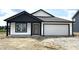 Charming single-story home featuring white siding, a two-car garage and contrasting black trim at 1319 Fleming Dr, Greenfield, IN 46140