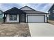 Charming single-story home with a two-car garage, dark trim, and a concrete driveway at 1319 Fleming Dr, Greenfield, IN 46140