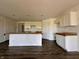 Open-concept kitchen with white cabinets, a large island, and dark wood-look flooring at 1319 Fleming Dr, Greenfield, IN 46140