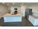 Bright kitchen features white cabinets, stainless steel appliances, an island with sink, and granite countertops at 1319 Fleming Dr, Greenfield, IN 46140