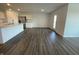 Open concept living area with hardwood floors that connect to the kitchen and a glass door leading to the outside at 1319 Fleming Dr, Greenfield, IN 46140