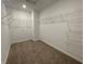 Walk-in closet that features carpet flooring, white walls, and white metal shelves at 1319 Fleming Dr, Greenfield, IN 46140