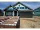 New home construction with a two-car garage, still being built with visible materials and builder wrap at 1338 Foxtail Ln, Greenwood, IN 46143