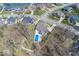 Aerial view highlighting a home with a pool, well-maintained landscaping, and neighborhood setting near the water at 13705 Beam Ridge Dr, McCordsville, IN 46055