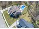 Aerial view featuring a private backyard with a swimming pool, patio area, and tree-lined property at 13705 Beam Ridge Dr, McCordsville, IN 46055