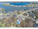 Aerial view showcasing the lake community, featuring a home with a pool surrounded by lush greenery and other houses at 13705 Beam Ridge Dr, McCordsville, IN 46055