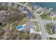 A high aerial view of a lakeside home and neighborhood featuring mature trees and a swimming pool at 13705 Beam Ridge Dr, McCordsville, IN 46055