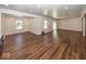 Finished basement with ample natural light, hardwood flooring and white walls at 13705 Beam Ridge Dr, McCordsville, IN 46055