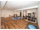 Spacious finished basement used as gym space with bright lights and dark hard wood flooring at 13705 Beam Ridge Dr, McCordsville, IN 46055