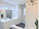 Bright bathroom featuring double sink vanity with modern lighting, walk-in shower, and decorative chandelier at 13705 Beam Ridge Dr, McCordsville, IN 46055