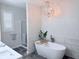 Bright bathroom featuring a soaking tub, a glass shower, and modern lighting fixtures at 13705 Beam Ridge Dr, McCordsville, IN 46055