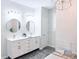 Bright bathroom featuring double vanities, round mirrors, and modern lighting fixtures at 13705 Beam Ridge Dr, McCordsville, IN 46055