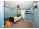 A cozy bedroom in blue with a wooden bedframe, bright lighting, and decorative shelves for displaying collections at 13705 Beam Ridge Dr, McCordsville, IN 46055