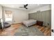 Comfortable bedroom featuring wood-look floors, a ceiling fan, and paneling for a classic look at 13705 Beam Ridge Dr, McCordsville, IN 46055