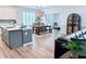 A dining room showcases an island, dining table with seating, an elegant light fixture, and abundant natural light at 13705 Beam Ridge Dr, McCordsville, IN 46055