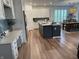 A modern kitchen with white cabinetry, an island with counter seating, stainless steel appliances, and stylish finishes at 13705 Beam Ridge Dr, McCordsville, IN 46055