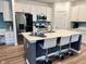 The kitchen features an island with seating, quartz countertops, modern appliances, and contemporary finishes at 13705 Beam Ridge Dr, McCordsville, IN 46055