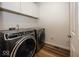 Laundry room featuring modern front load washer and dryer and upper cabinets for storage at 13705 Beam Ridge Dr, McCordsville, IN 46055
