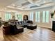 Open-concept living room featuring a modern fireplace, hardwood floors, recessed ceilings, and a comfortable seating area at 13705 Beam Ridge Dr, McCordsville, IN 46055