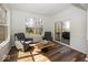 Bright living room with large windows, comfortable seating, and a unique wooden coffee table at 13705 Beam Ridge Dr, McCordsville, IN 46055