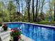 Beautiful in-ground pool showcasing clear water and a surrounding landscape that creates a private, tranquil oasis at 13705 Beam Ridge Dr, McCordsville, IN 46055