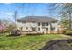 Expansive backyard with a well-maintained lawn, a deck with outdoor seating, and privacy trees at 14491 Jeremy Dr, Carmel, IN 46033