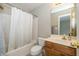 Bathroom featuring a shower-tub combo, vanity, and updated fixtures at 14491 Jeremy Dr, Carmel, IN 46033