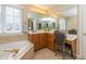 Bathroom vanity featuring double sinks, and a large mirror with vanity lighting at 14491 Jeremy Dr, Carmel, IN 46033