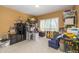 Cluttered bedroom with carpeted floors, window, and a variety of storage shelves and containers at 14491 Jeremy Dr, Carmel, IN 46033