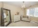 Bedroom with neutral colors, decorative chandelier, plush seating, and a large mirror at 14491 Jeremy Dr, Carmel, IN 46033