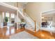 Grand foyer with hardwood floors, staircase, and views into the living and dining rooms, creating an open and welcoming atmosphere at 14491 Jeremy Dr, Carmel, IN 46033