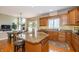 The updated kitchen features stainless appliances, granite counters, breakfast bar, and a sunlit breakfast nook at 14491 Jeremy Dr, Carmel, IN 46033