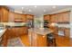 Updated kitchen featuring granite countertops, wood cabinetry, stainless steel appliances, and a large island at 14491 Jeremy Dr, Carmel, IN 46033