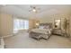 Spacious main bedroom with plush carpeting, a tray ceiling, and large windows for natural light at 14491 Jeremy Dr, Carmel, IN 46033