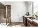 Bathroom showcasing a glass shower, double vanity, and tile floors at 15144 Bentfield Ct, Fishers, IN 46037