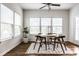 Sun-filled dining area features a ceiling fan, large windows, and a cozy breakfast nook at 15144 Bentfield Ct, Fishers, IN 46037