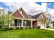 Charming home exterior showcasing a well-manicured lawn, stone accents, decorative shutters, and a two-car garage at 15144 Bentfield Ct, Fishers, IN 46037