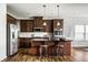 Well-equipped kitchen features stainless steel appliances, dark wood cabinets, and a stylish center island at 15144 Bentfield Ct, Fishers, IN 46037